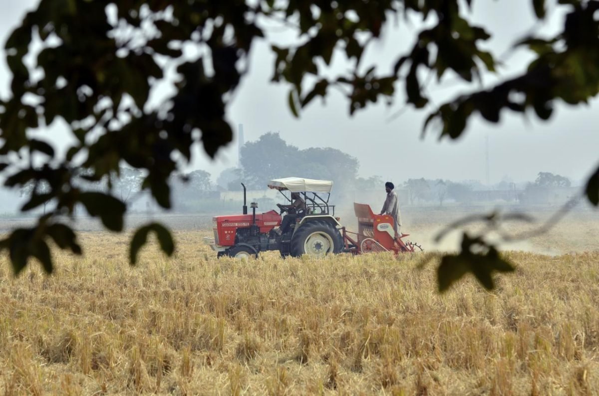 A tractor pulling a Happy Seeder through rice stubble in a field near Sangrur