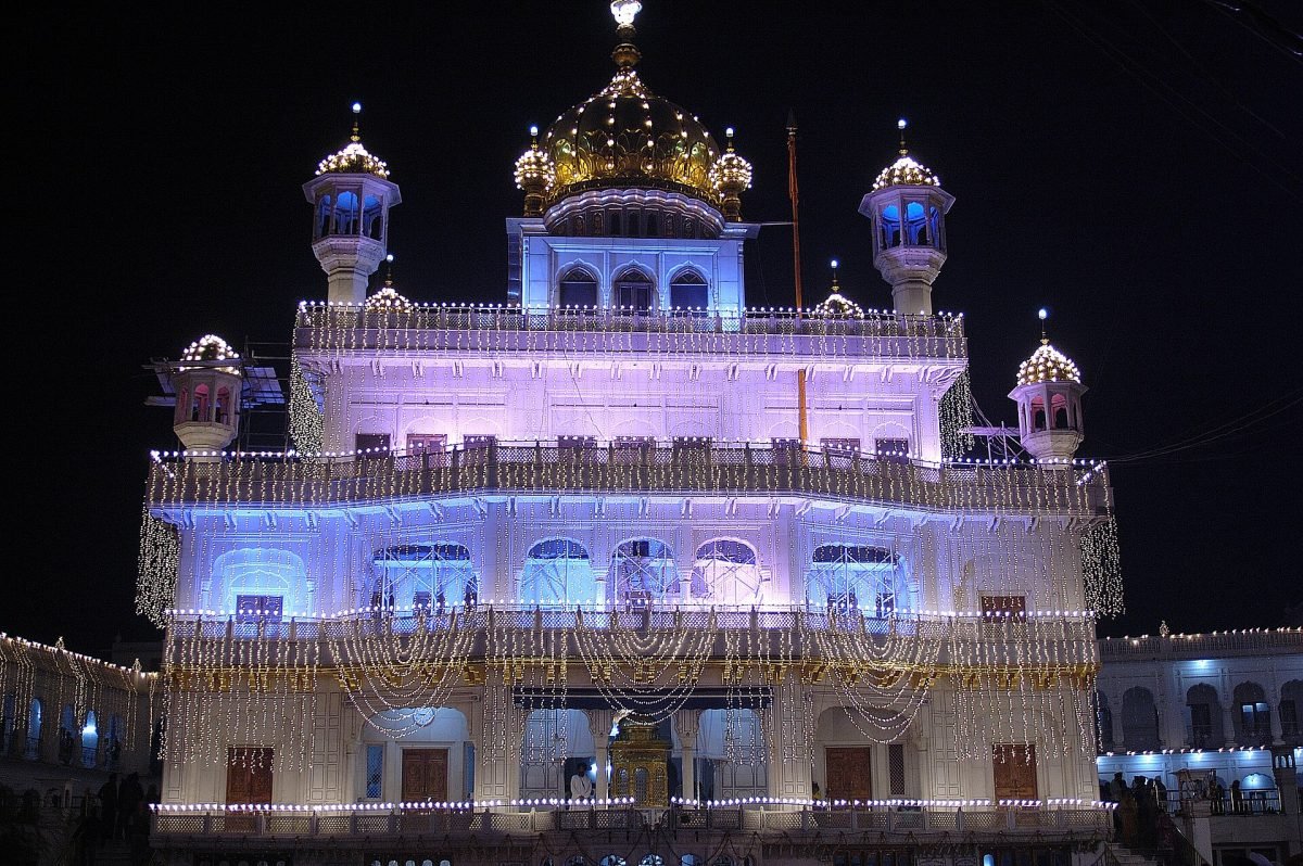 The Akal Takht lit up at night in the Golden Temple complex