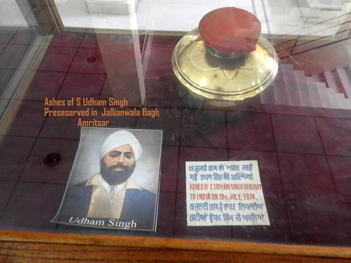 A small urn behind glass in a museum display case, with a framed caption
