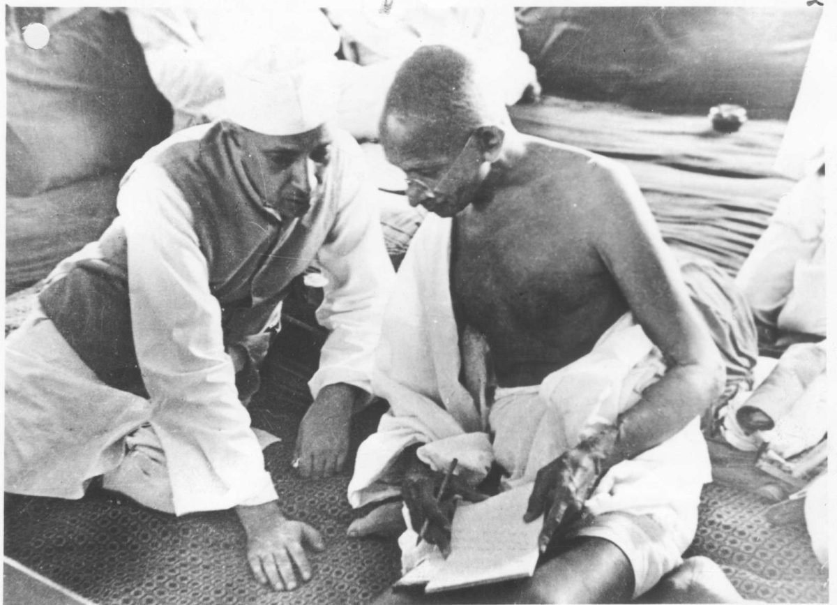 Gandhi and Jawaharlal Nehru sitting close together in conversation, 1942