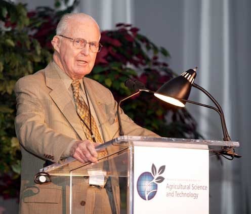 Head-and-shoulders portrait of Norman Borlaug, an older man in glasses