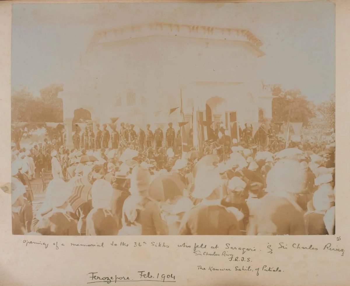 An old photograph of a crowd and soldiers gathered outside a small domed memorial building
