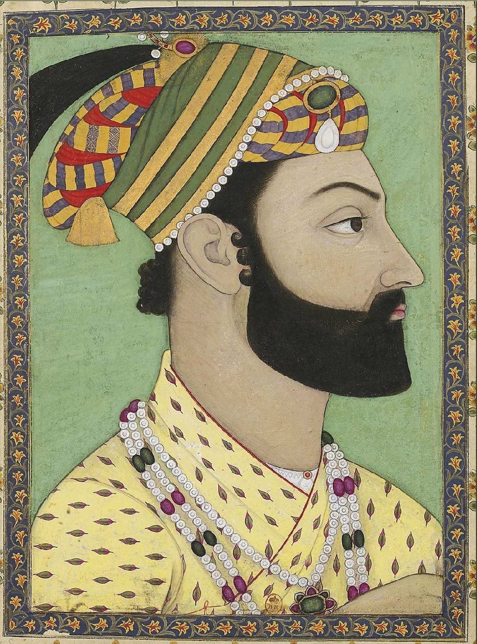 A Mughal miniature of a bearded king in a plumed turban and patterned robe, seated on a carpet