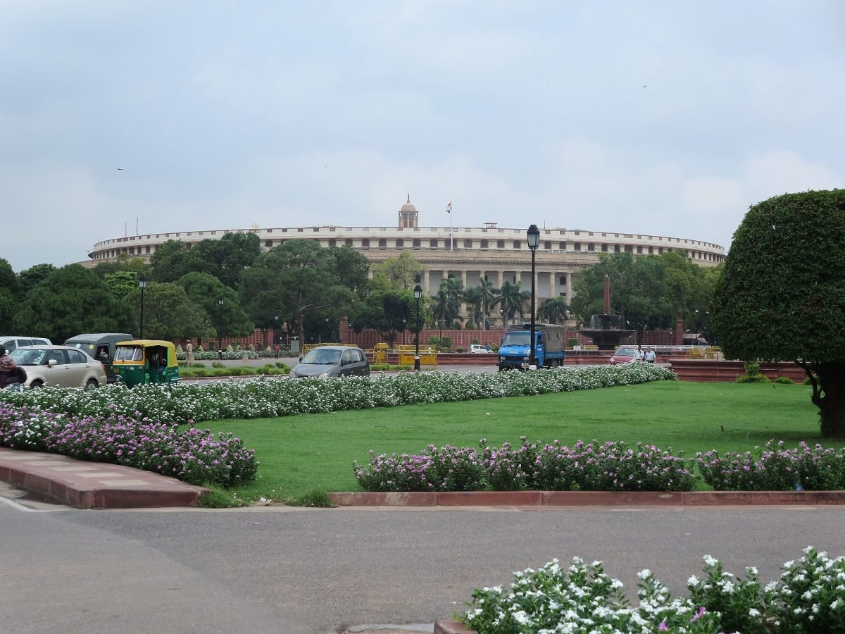The circular old Parliament House in New Delhi, with its long colonnade, seen from Vijay Chowk