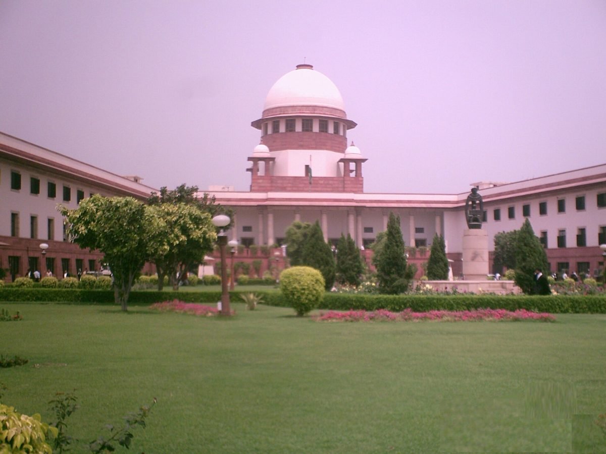 The domed Supreme Court of India building in New Delhi behind its perimeter wall and gardens