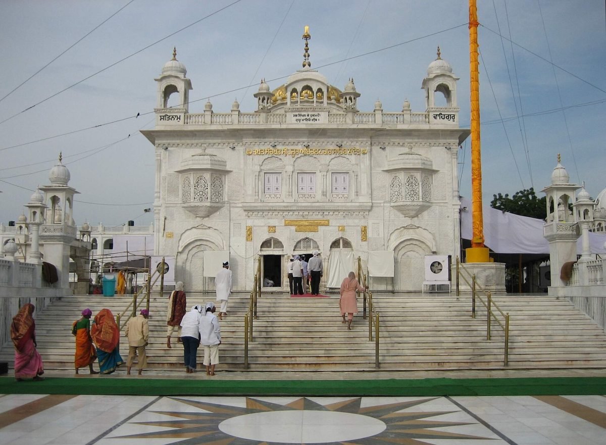 A white gurdwara with a golden dome at Nanded